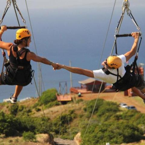 a person flying through the air over a body of water