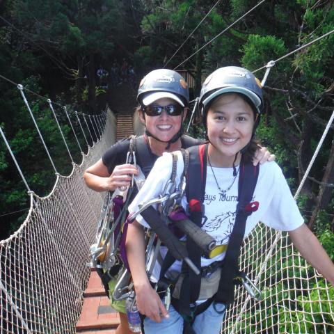 a man and a woman standing next to a fence
