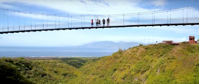 2020-01-23_16-41-27 People standing on the Kapalua Suspension Bridge with sky and a hill in the background