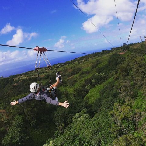 a man flying through the air on top of a hill