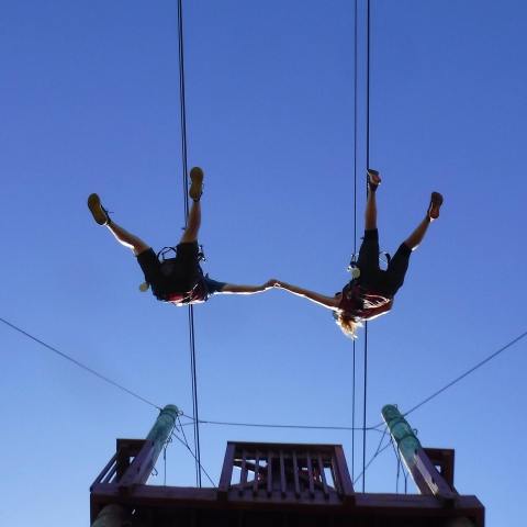 a group of people standing on top of a pole