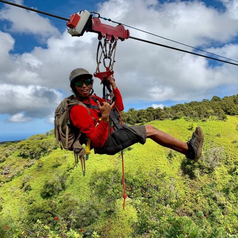 a man standing on a grassy hill
