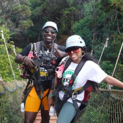 a person standing next to a fence